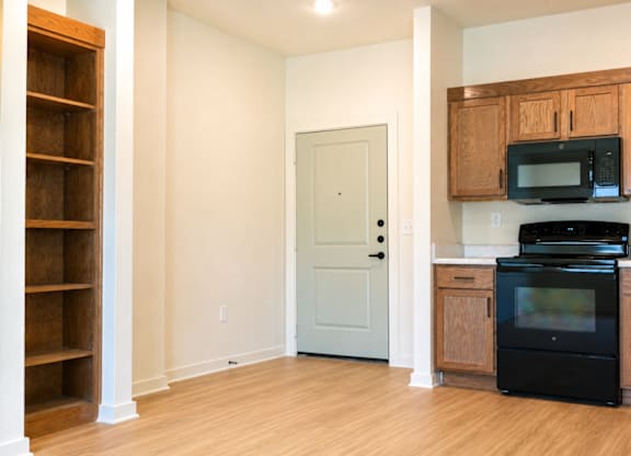 A kitchen with wooden cabinets and appliances.