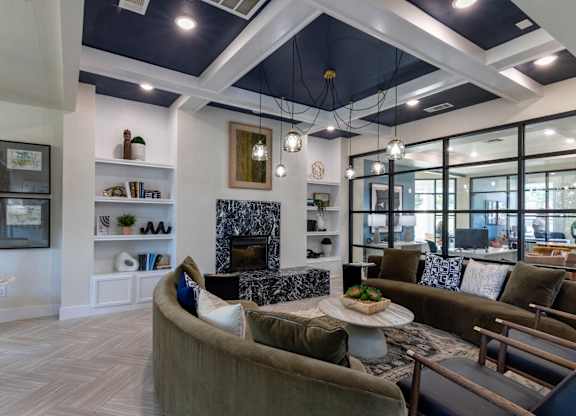A modern living room with a fireplace and a large window.