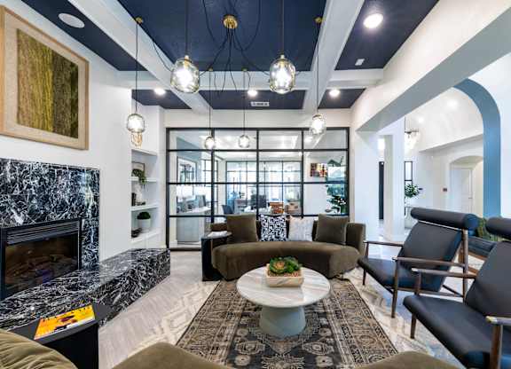 A modern living room with a fireplace and comfortable seating.