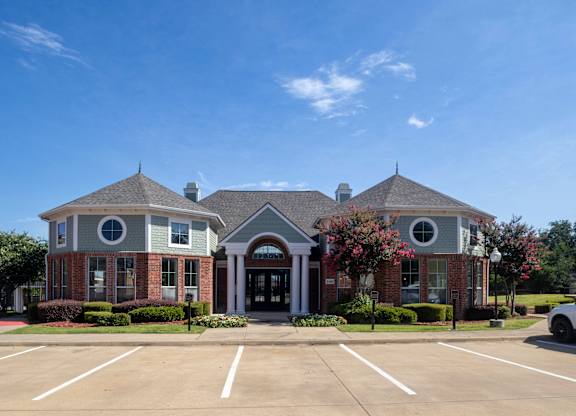A building with a parking lot in front of it.
