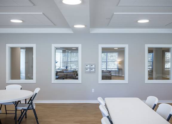 A conference room with a white table and chairs.