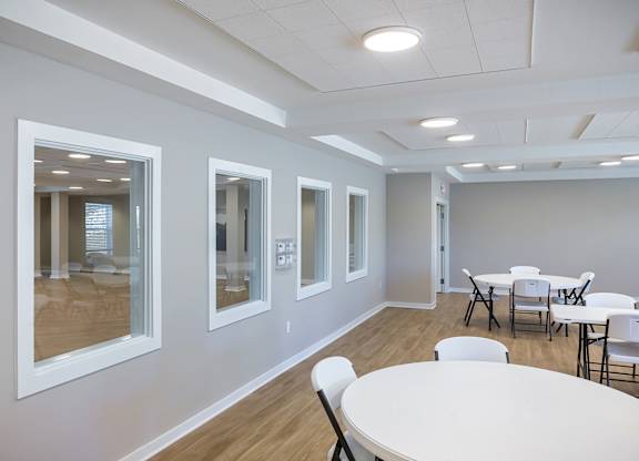 A conference room with a white table and chairs.