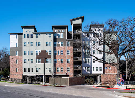A large apartment complex with multiple buildings and balconies.