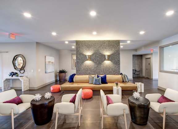 A living room with a white couch and a brown coffee table.