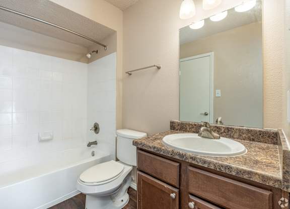 A bathroom with a white toilet and a white sink.