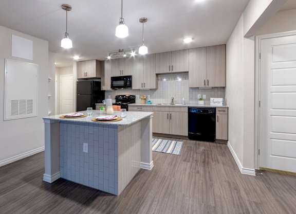 A kitchen with a table and chairs set for two.
