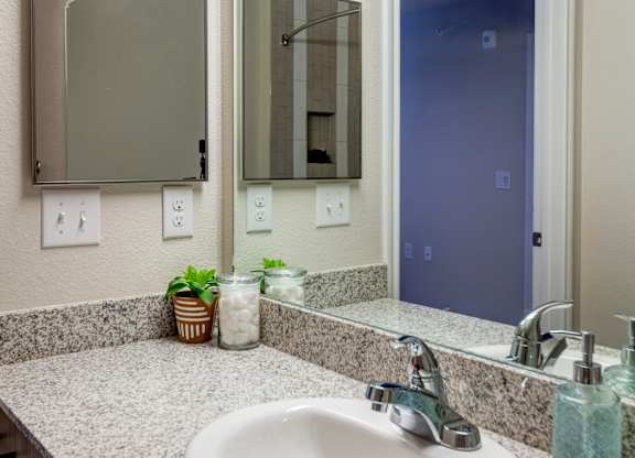 A bathroom sink with a mirror above it.