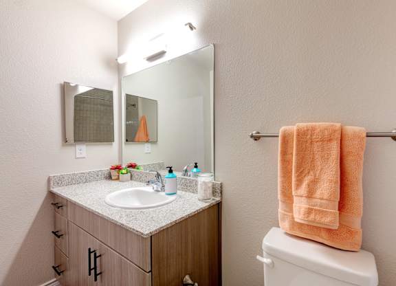 A bathroom with a towel hanging on a towel rack.