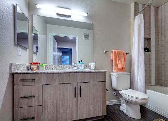 A bathroom with a toilet, sink, and a bathtub.