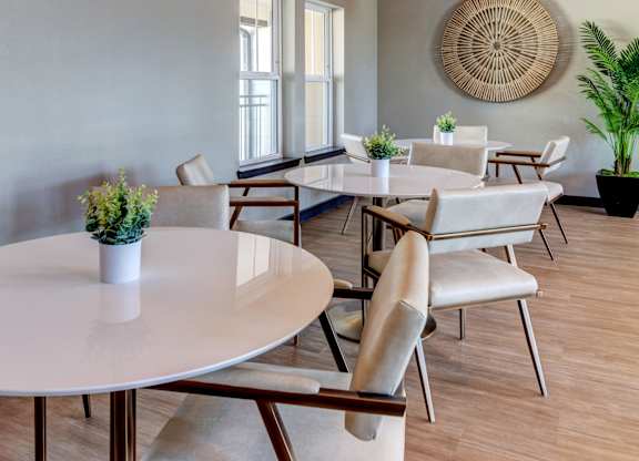 A dining room with a white table and chairs.