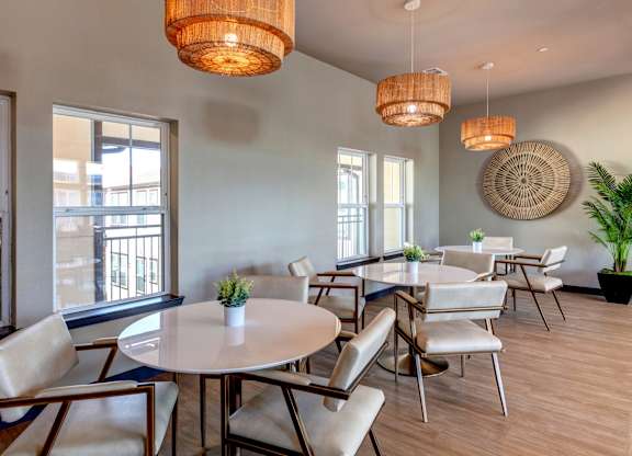 A dining room with a round table and chairs.