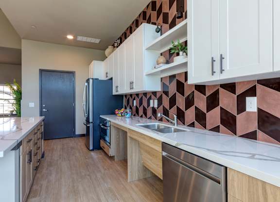 A kitchen with a blue refrigerator and wooden cabinets.