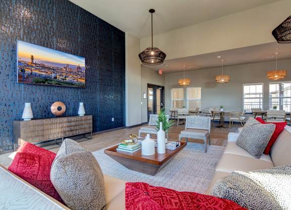A living room with a large couch, a coffee table, and a painting on the wall.