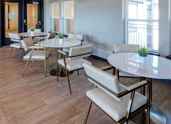 A dining room with a round table and chairs.