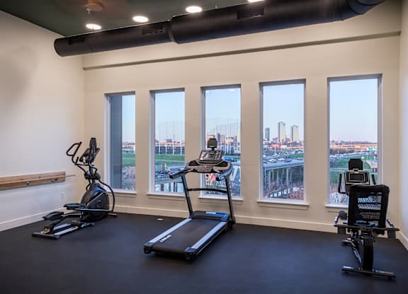 A gym with treadmills and exercise bikes.
