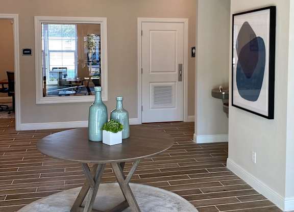 A modern dining room with a round table and a chandelier.