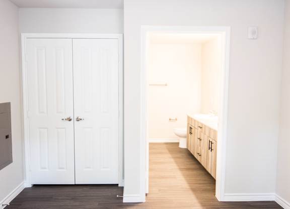 A white bathroom with a toilet and sink.