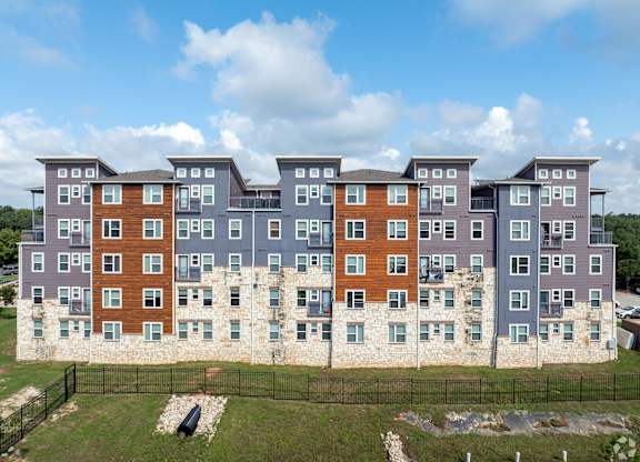A large apartment complex with multiple buildings and balconies.