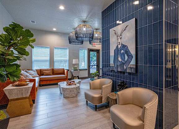 A living room with a large painting of a rabbit on the wall.