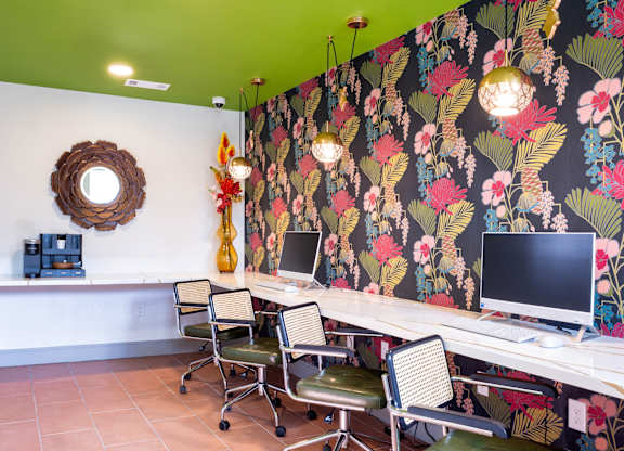 A room with a green ceiling and a floral wallpaper.