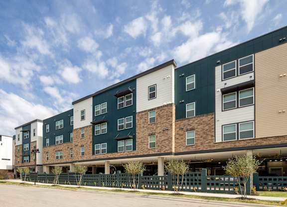 A large apartment complex with multiple buildings and balconies.