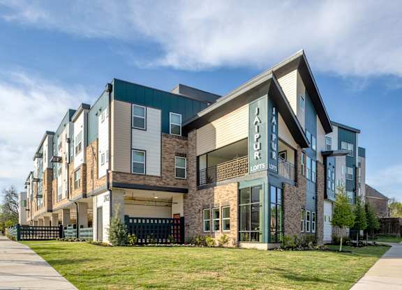A modern apartment complex with a sign that reads "Happy Home".