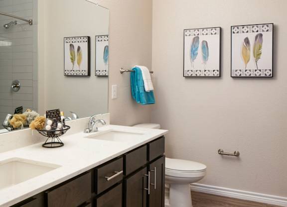 A bathroom with a white sink and a toilet.