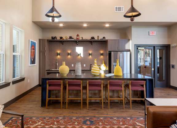 A dining area with a long table and chairs.