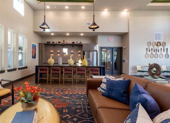 A living room with a brown couch and a wooden coffee table.