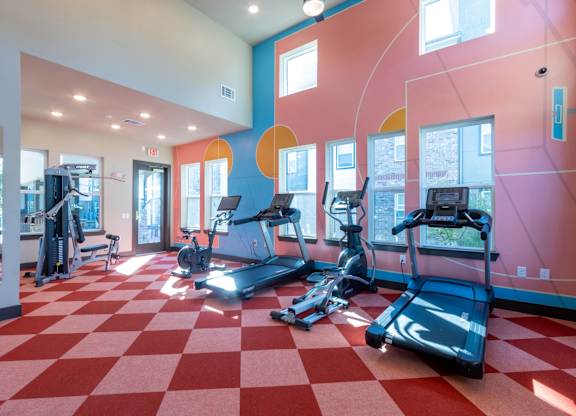 A gym with treadmills and exercise equipment.