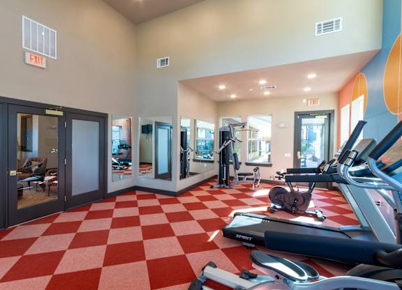 A gym with a red and white checkered floor.