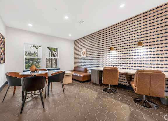 A room with a brown tiled floor and a wall with a patterned tile design.
