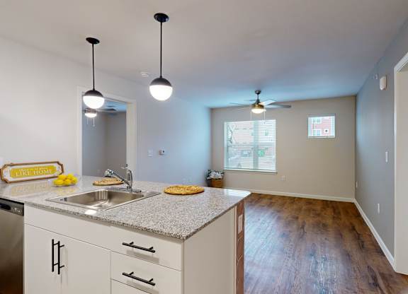 A kitchen with a granite countertop and a refrigerator.