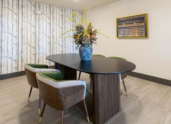 A dining room with a round table and chairs.