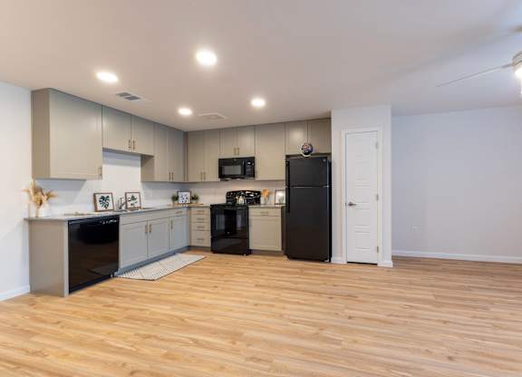 A kitchen with wooden floors and modern appliances.