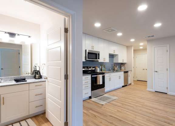 A kitchen with white cabinets and a wooden floor.