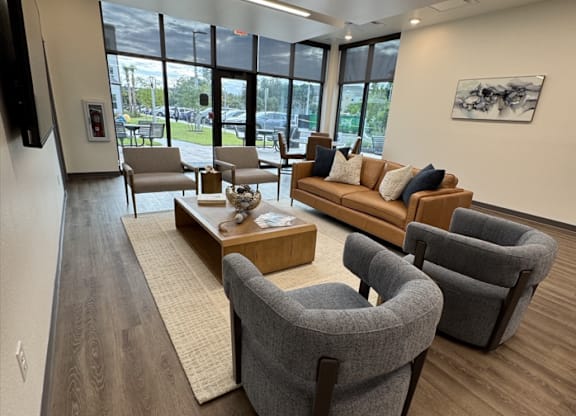 A modern waiting room with comfortable seating and a view of the outside.