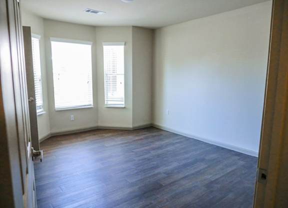 A room with wooden floors and white walls.