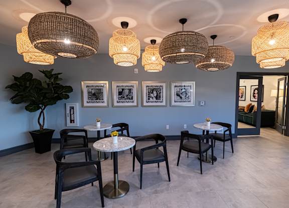 A room with a table and chairs and pictures on the wall.