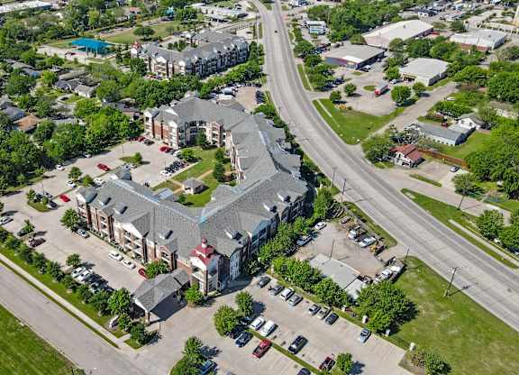 A large building with a parking lot in front of it.