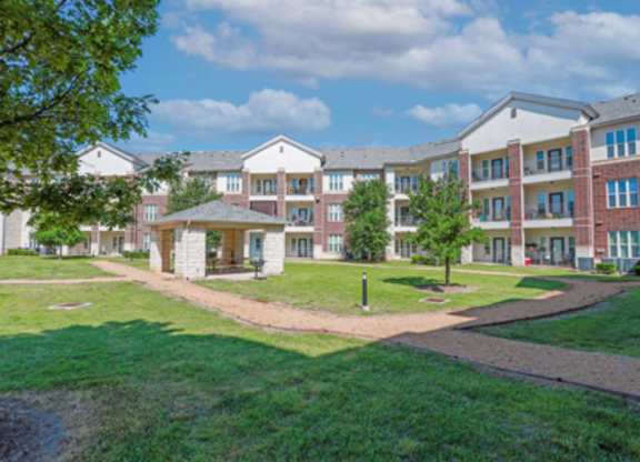 A large building with a grassy area in front of it.
