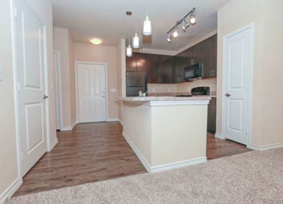 A kitchen area with a counter and cabinets.