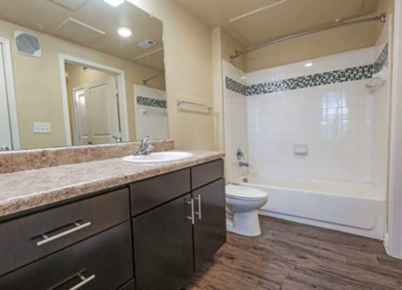 A bathroom with a sink, toilet, and bathtub.