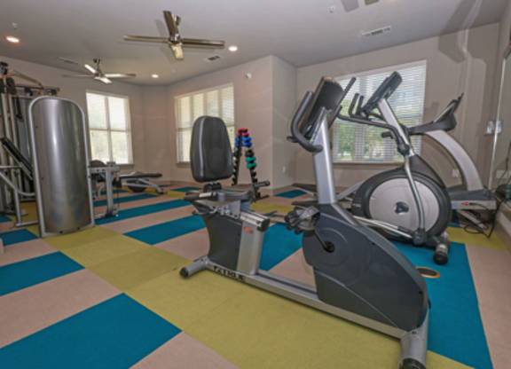 A room with a treadmill and exercise equipment.
