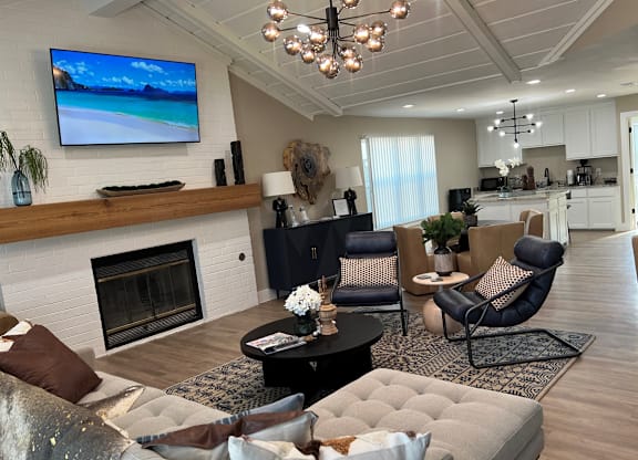 A modern living room with a fireplace and a flat screen TV mounted on the wall.