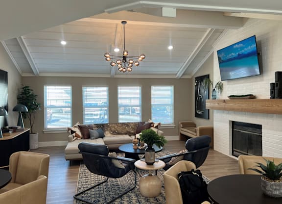 A living room with a fireplace and a television mounted on the wall.