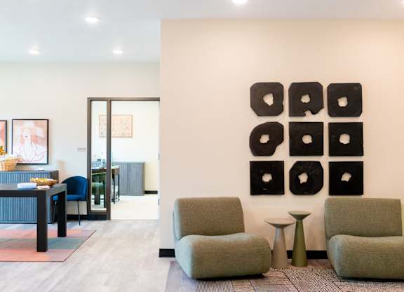 A modern living room with a large abstract artwork on the wall.