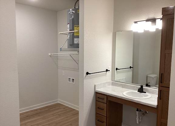 A bathroom with a sink, mirror, and medicine cabinet.