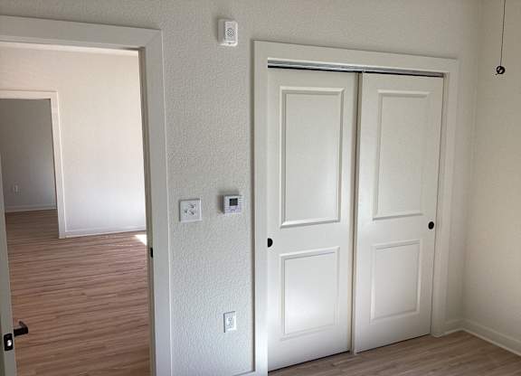 A white door is on the right and a white wall is on the left.