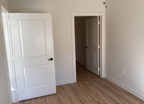 A white door is open to a hallway.